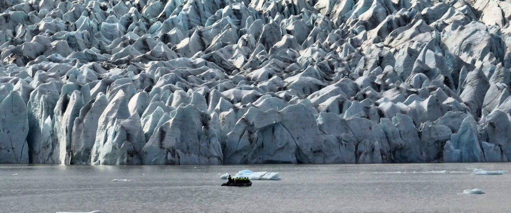 A zodiac boat up close to Fjallsjökull glacier