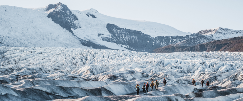 Hikers hiking up on to Fjallsjökull glacier.